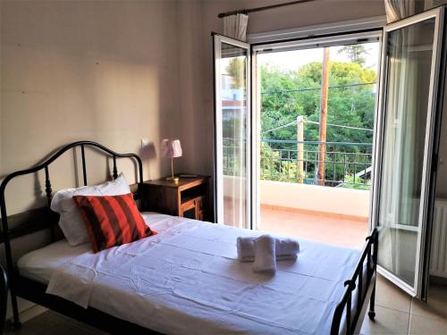 a bedroom with a bed and a sliding glass door at Aegean Sea Home in Nea Makri
