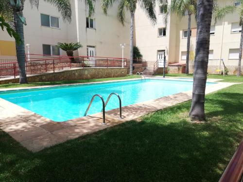 a swimming pool in front of a building at Les Palmeres Centre in Les Cases d'Alcanar