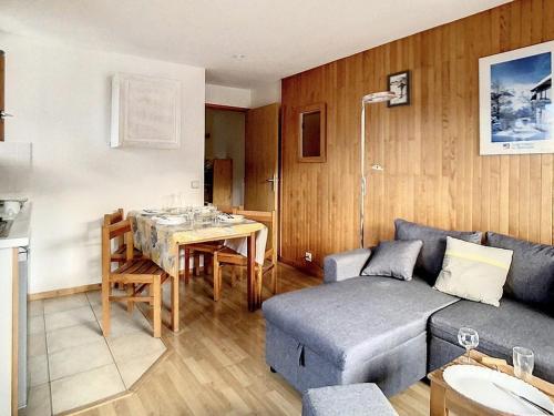 un salon avec un canapé et une table dans l'établissement Appartement cosy au pied des pistes avec parking et balcon, 4 pers, centre village - FR-1-344-1077, à Saint-Martin-de-Belleville