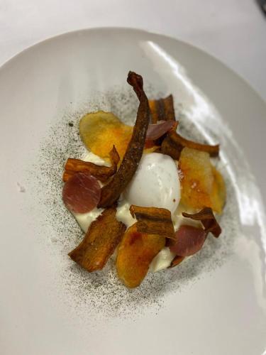 a plate of food with bacon and ice cream at Chateau des Ducs de Joueuse, BW Signature Collection in Couiza