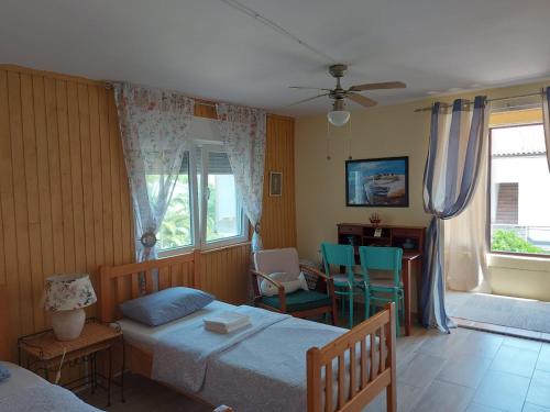 a bedroom with a bed and a table and chairs at Premantura Studio apartman in Premantura