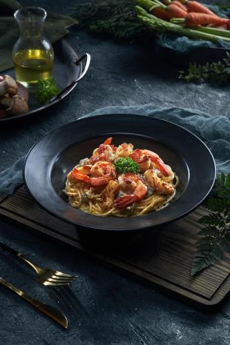 a plate of food with shrimp on top of pasta at Canary Dalat Hotel in Da Lat