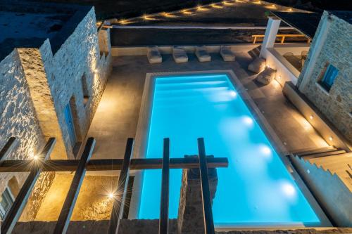 an overhead view of a swimming pool at night at Anemela Villas & Suites Mykonos in Agrari