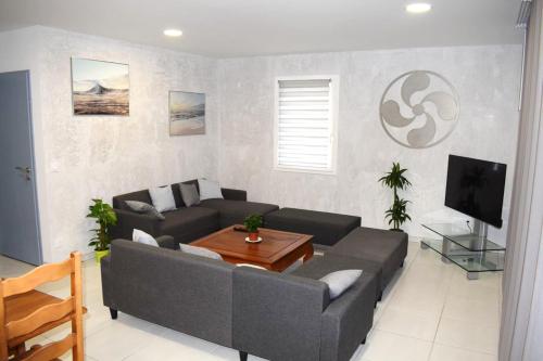 a living room with a couch and a table at Maison "Gure Zerua", Pays Basque in Cambo-les-Bains