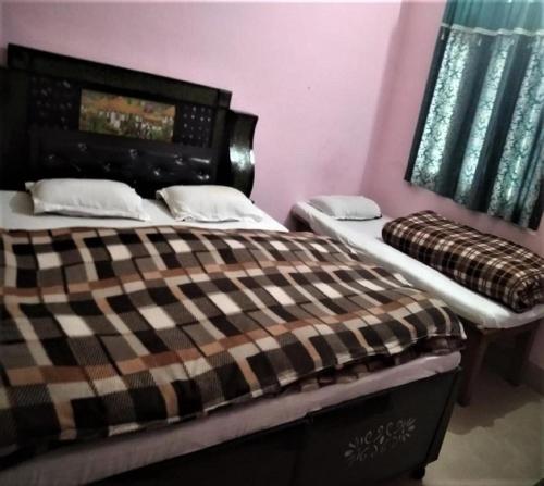 a bedroom with two beds in a room at Ashish Bed & Breakfast by StayApart in Ukhimath