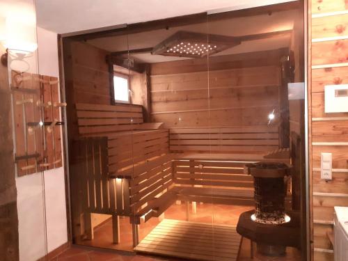 una sauna con puerta de cristal en una habitación en Schönberghütte, en Lachtal