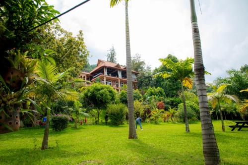 a resort in the middle of a park with palm trees at Hakuna Matata Lodge in Gisenyi