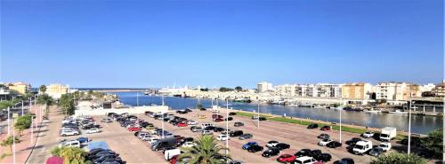 ガンディアにあるApartamento Bella Vista Solo Familiasの水辺に停車する車だらけ駐車場