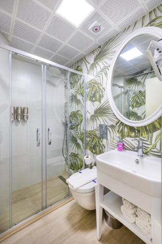 a bathroom with a shower and a toilet and a sink at Princess Kinli Suites Hotel in Marmaris
