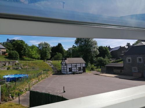 a view of a playground from a window at Là ou je t 'amènerai in Gedinne