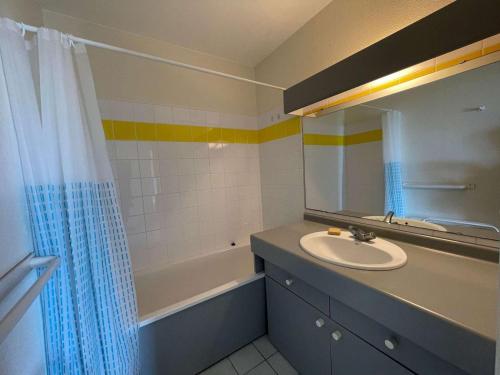 une salle de bain avec un lavabo, un miroir et une baignoire dans l'établissement Appartement 3 pièces avec piscine et parking à Saint-Jean-de-Monts - FR-1-224C-111, à Saint-Jean-de-Monts