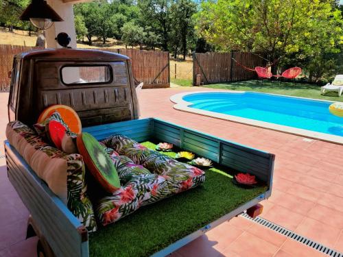 a truck bed with a couch next to a swimming pool at Harveys Homestay - Adults only in Mieres