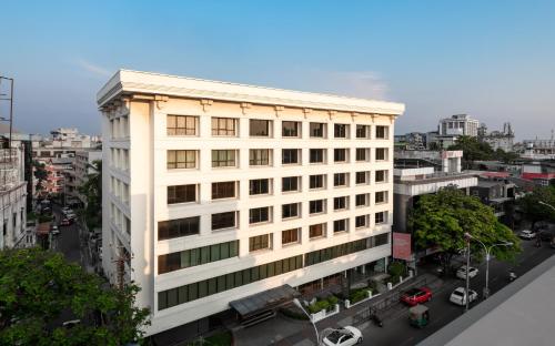 an overhead view of a white building in a city at The Avenue Regent in Cochin