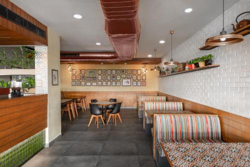 a restaurant with chairs and a table in a room at The Avenue Regent in Cochin