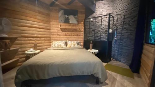 a bedroom with a large bed and two tables at L 58 LODGE de LUXE in Lège-Cap-Ferret