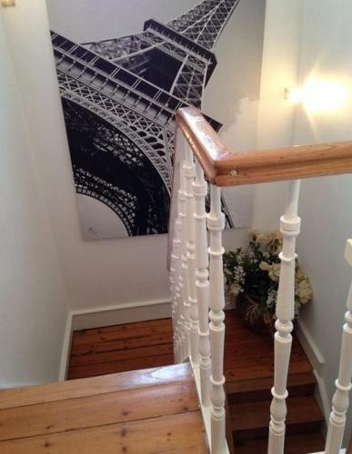 a staircase with a picture of the eiffel tower at Chambres et Table d'hôtes La Belle Lensoise in Lens