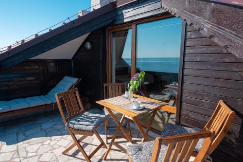 a table and chairs on a patio with a view at Guest House Doctor's House in Sozopol
