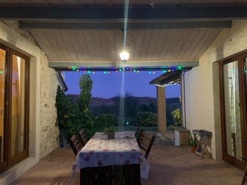 a table on a patio with a view of the mountains at Il Nido del Falco nelle Antiche Mura in Saturnia
