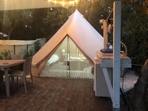 a white tent with a table and a tableablish at Sunseabeach in Marzamemi