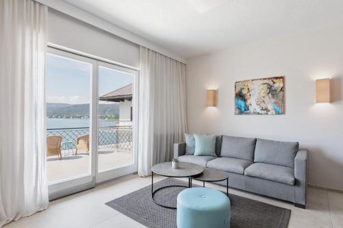 a living room with a couch and a table at Hotel Linde in Maria Wörth
