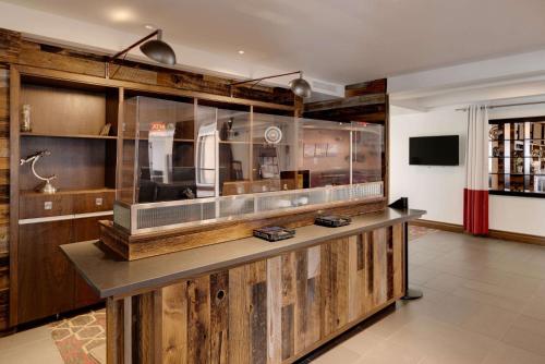 a large room with a counter with wooden walls at The Crossroads Hotel - Newburgh in Newburgh