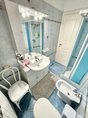 a bathroom with a white sink and a mirror at Alexander's Home in Collecorvino