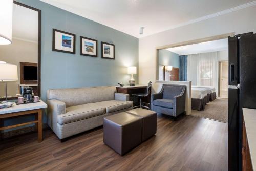 a hotel room with a couch and a bed at MainStay Suites Orange County John Wayne Airport in Santa Ana