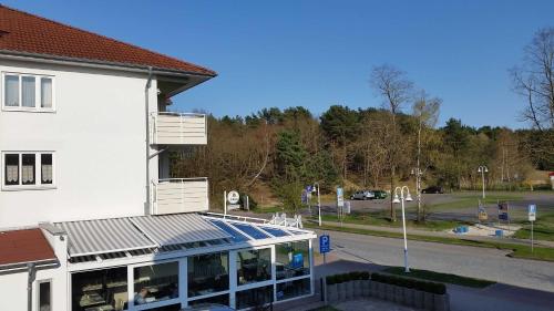 a large white building with a parking lot at Fewo Ostseeperle 14_QUAP in Ostseebad Karlshagen