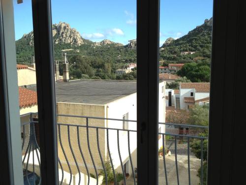 a view of a mountain from a window at Antica Dimora La Corona in San Pantaleo
