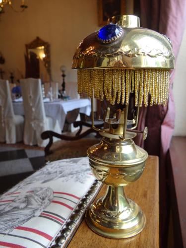 a gold lamp sitting on top of a table at Chambres d'Hôtes Le Grismoustier in Veulettes-sur-Mer