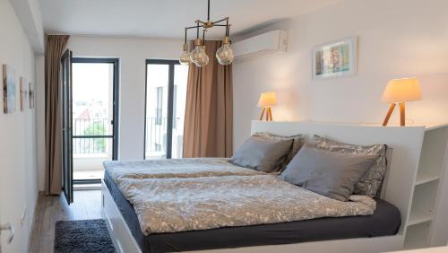 a bedroom with a bed in a room at Mali apartment Varna in Varna City