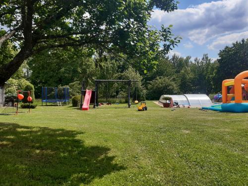a park with a bunch of playground equipment in the grass at Apartmány Roudnice in Jestrabi V Krkonosich