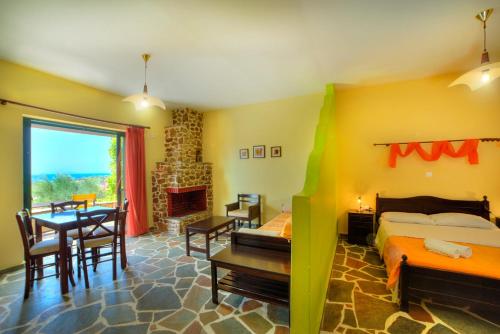 a bedroom with a bed and a dining room with a table at Ktima Nikola in Marmarion