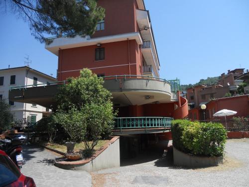 a red building with a balcony on the side of it at Hotel La Querceta in Montecatini Terme