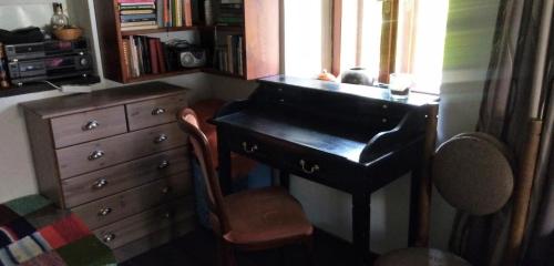 escritorio con silla y tocador en una habitación en Útulný domek s malou zahrádkou, en Dačice
