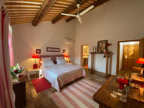 a bedroom with a bed and a table with lamps at La ferme de gigognan in Avignon