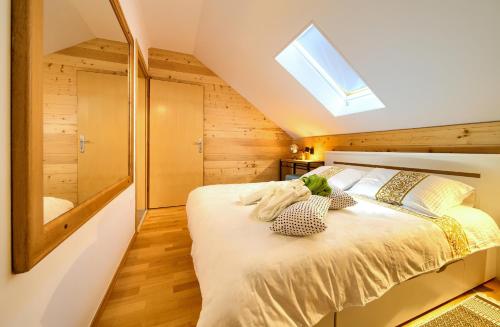 a bedroom with a bed and a skylight at Layla in Fužine