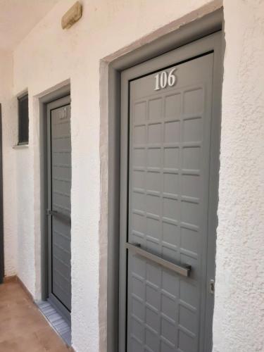 a pair of garage doors with the number on them at Ostria in Agia Galini