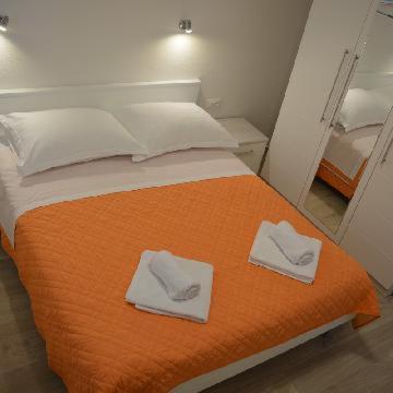 Postel nebo postele na pokoji v ubytování Apartments Leon