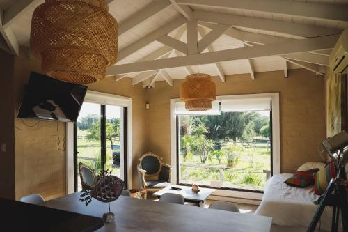 a room with a bed and a large window at Finca Soñada in Colonia del Sacramento