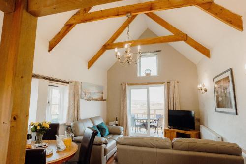 a living room with a couch and a table at Celtic Haven in Tenby