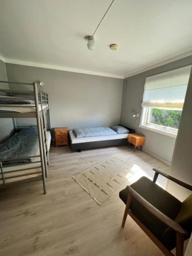a room with two bunk beds and a chair at Lyngen House in Olderdalen