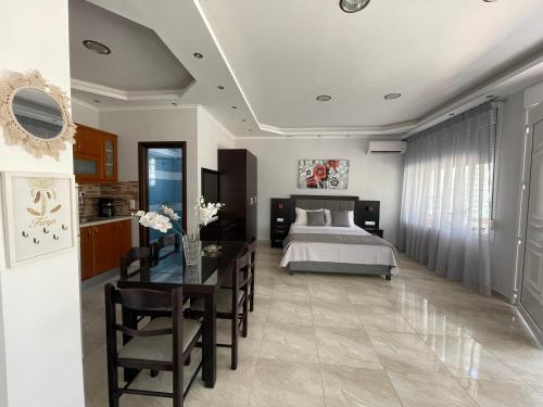 a bedroom with a bed and a table and a dining room at Villa Elsa in Skala Rachoniou