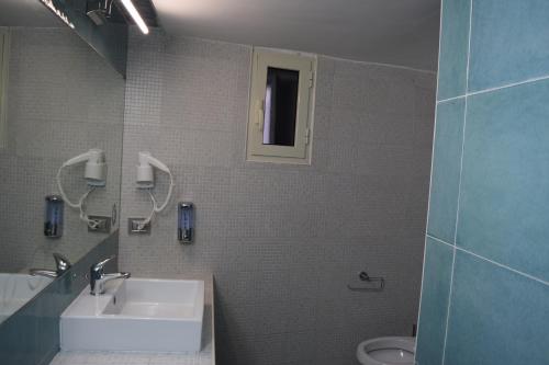 a bathroom with a sink and a toilet at Dimora D’alessandro in Naples