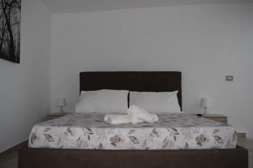 a bedroom with a bed with two towels on it at Dimora D’alessandro in Naples