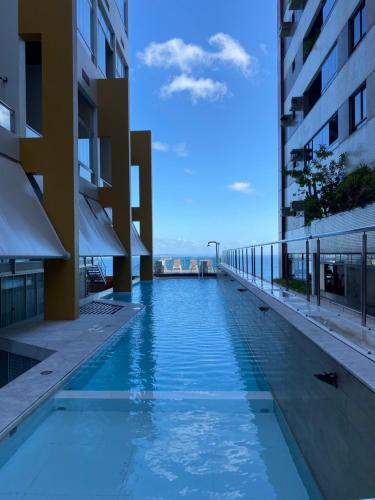 a swimming pool in the middle of a building at Vitoria Loft 403 in Salvador