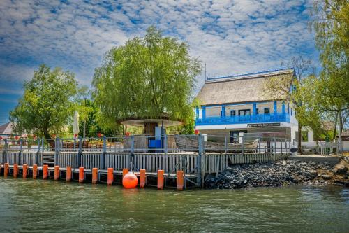 a dock in the water in front of a building at Delta Boutique & Carmen Silva Resort in Crisan