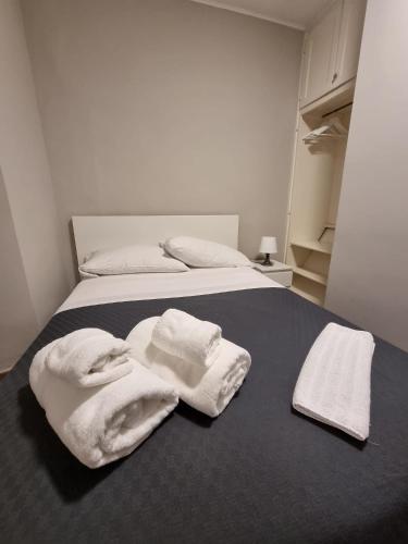 a bed with white towels on top of it at Osteria Pozzo in Locarno
