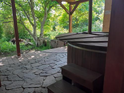 an outdoor patio with a stone walkway and trees at Willa Bawarczyk in Istebna