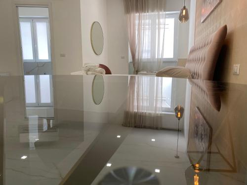 a living room with two mirrors on the wall at Maison De luxe in Pompei